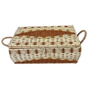 May include: A woven storage box with a lid and two handles. The box is made of brown and white rope and has a geometric pattern.