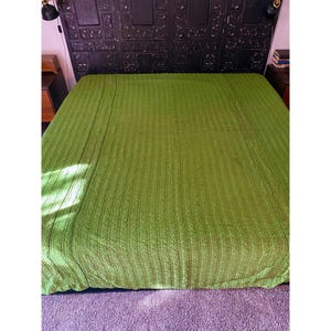 May include: A green quilted bedspread with a textured pattern. The bedspread is made of a soft, comfortable material and is perfect for adding a touch of color to any bedroom.
