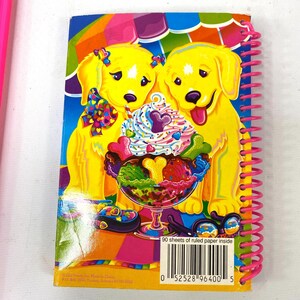 May include: A spiral-bound notebook with a colorful cover featuring two yellow cartoon puppies. The puppies are next to a large ice cream sundae. The notebook has a pink spiral binding and the text "90 sheets of ruled paper inside".