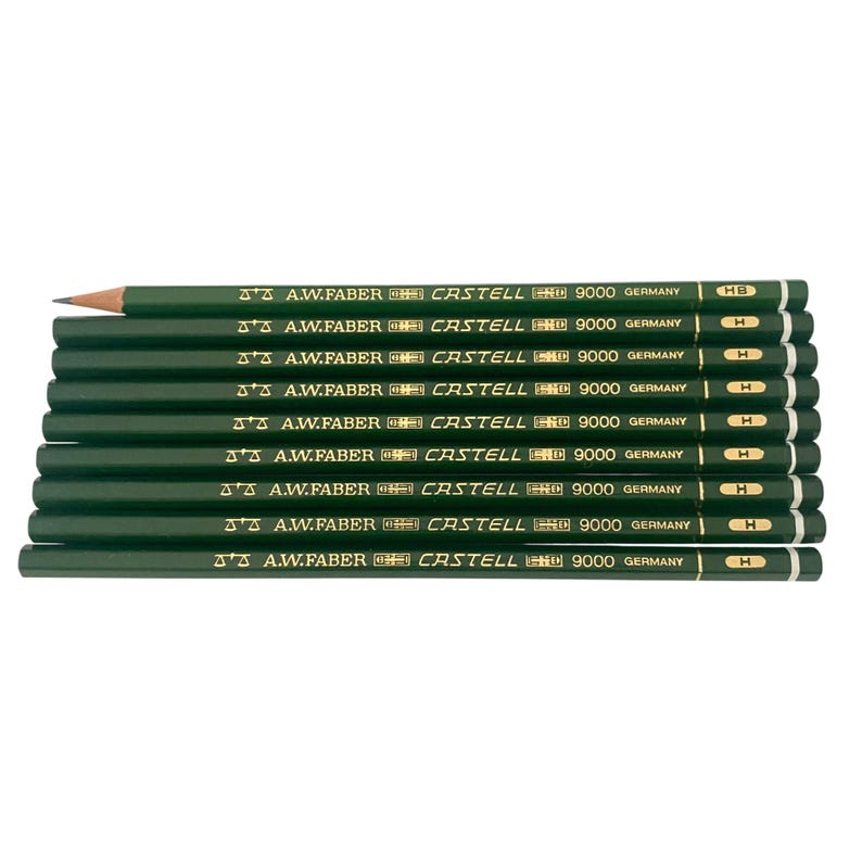 May include: A stack of ten dark green pencils with the text "A.W. Faber Castell 9000 Germany" printed on each. One pencil is sharpened, showing the graphite tip. The pencils are arranged horizontally, with the tips pointing to the left.