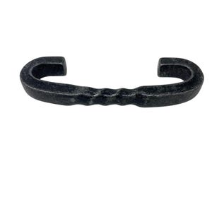 May include: A hand-forged, black iron handle with a curved design. The handle features a textured, ridged center section and curved ends, creating a sturdy and rustic aesthetic. Ideal for cabinet doors or drawers.