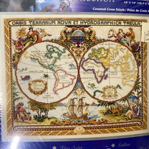 May include: Cross-stitch kit with a detailed world map design. The map, titled "ORBIS TERRARUM NOVA ET HYDROGRAPHICA TABULA," features illustrations of ships, figures, and geographical details. The finished piece measures 45.7 x 38.1 cm.