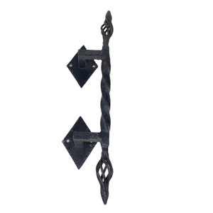 May include: Black wrought iron door handle with a twisted design and diamond-shaped plates.