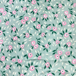 May include: A light mint green fabric featuring a repeating pattern of small pink flowers with dark green leaves and scattered white petal shapes. The textile has a soft, woven texture with a consistent floral print across the entire surface.
