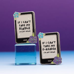 May include: Two rectangular metal enamel pins shaped like e-readers. One pin features the text IF I CAN'T TAKE MY KINDLE I'M NOT GOING, and the other reads IF I CAN'T TAKE MY E-READER I'M NOT GOING. Both pins are decorated with blue and purple flowers.