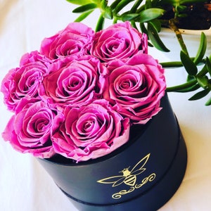 Preserved roses in a round personalized gift box. Purple roses in a black round box. Orly Bee Designs