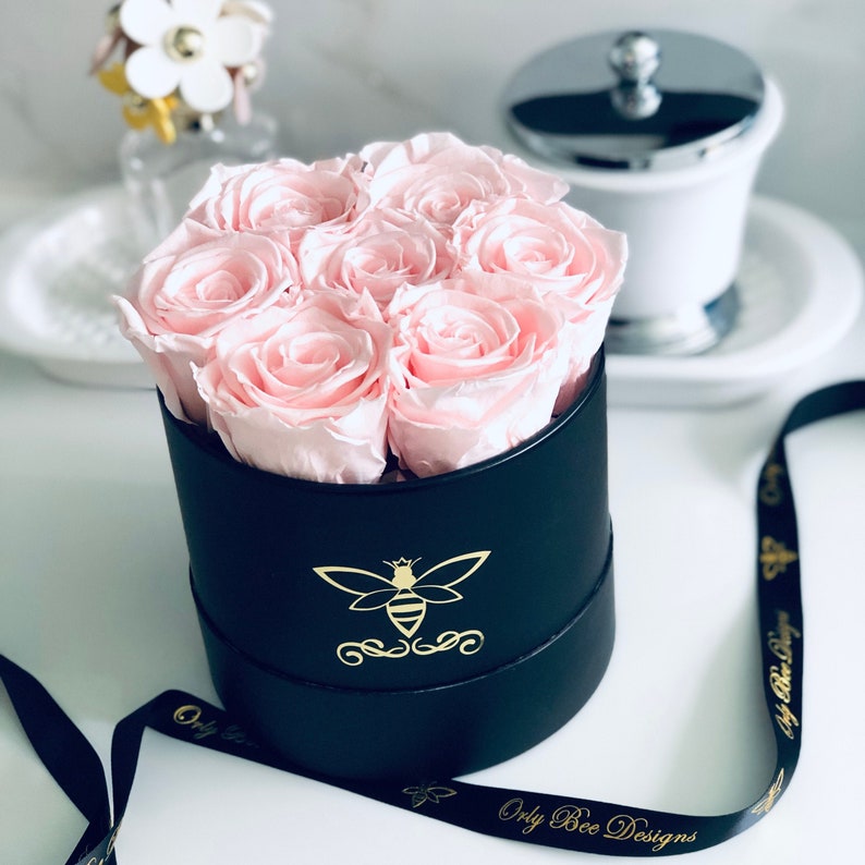 Preserved roses in a round personalized gift box. Light pink roses in a black round box. Orly Bee Designs