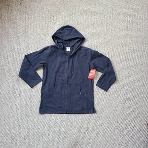 May include: A navy blue hooded jacket with a front pocket and a zipper closure. The jacket has long sleeves and a hood. A red tag is attached to the jacket. The jacket is made of a textured fabric.