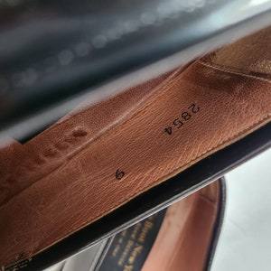May include: Close-up of the inside of a brown leather shoe with the number 2894 and the size 6 printed on the insole.
