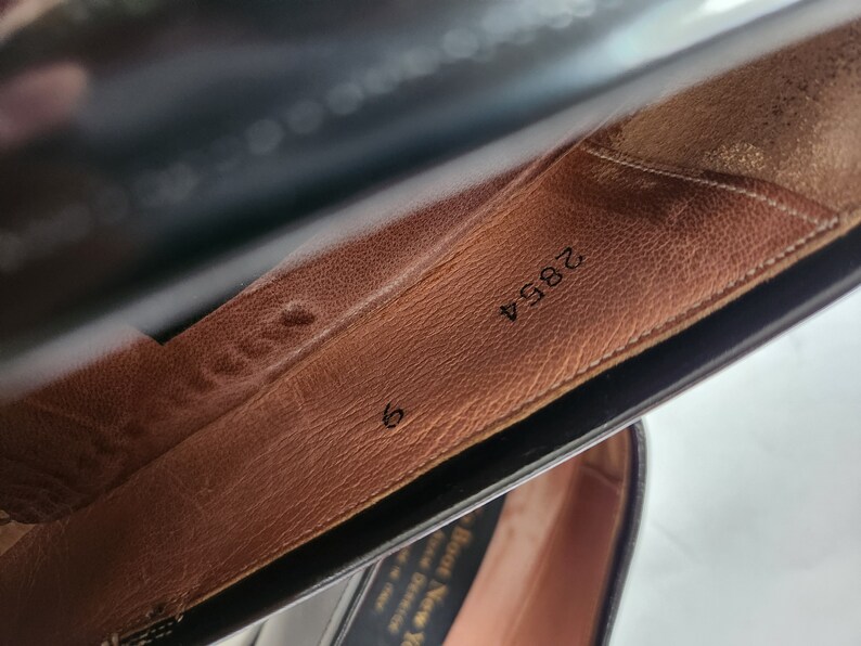 May include: Close-up of the inside of a brown leather shoe with the number 2894 and the size 6 printed on the insole.