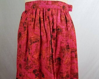 May include: A vintage, high-waisted skirt in a vibrant fuchsia hue, adorned with an all-over pattern of orange and black abstract shapes. The skirt features a gathered waist and a simple, elegant design, perfect for a retro-inspired look.
