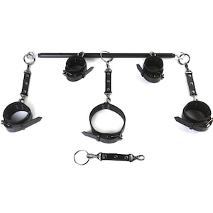 May include: Black leather restraints with metal hardware and a metal bar. The restraints are connected to the bar with metal rings. There is also a separate black leather strap with metal rings.