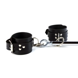 May include: A pair of black leather cuffs featuring silver-toned metal hardware, including buckles, rivets, and D-rings. The cuffs are connected to a central chrome-finished metal spreader bar by a series of interlocking metal rings and eye bolts.
