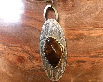 Fire agate gallery set on lace patterned sterling silver pendant