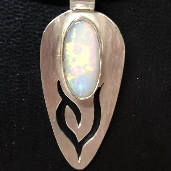 A light colored opal set on a filiagree sterling silver pendant