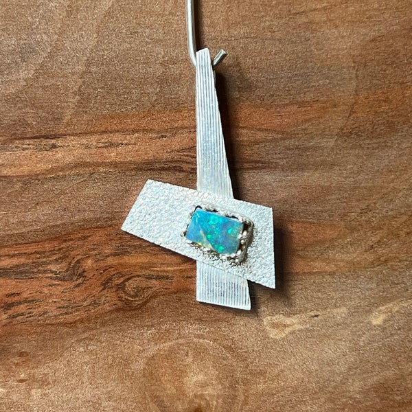 An Australian Boulder opal set on a Sterling silver pendant pendant