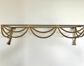 Twisted gold metal shelf with swag details, tassels, excellent condition, no glass included; measures  18.75" wide x 5.5" tall x 5.5" deep.