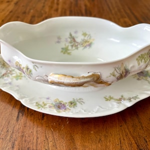 Vintage Haviland Limoges gravy boat, attached underplate, sprigged florals on white china, gold painted details, lovely! 10&quot; x 6&quot; x 3 1/8&quot;.