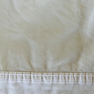 Queen-sized flat or fitted solid cream-colored bed sheets bye HomeTrends, 60 cotton, 40 polyester, excellent condition.