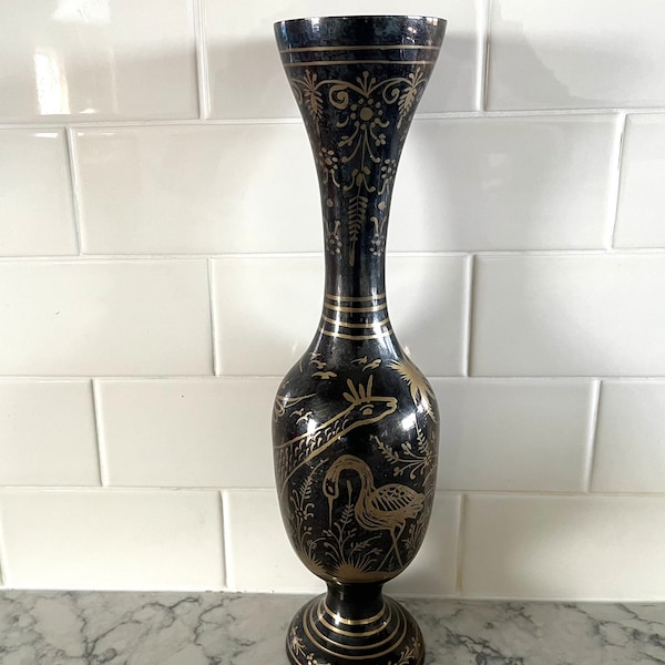 Tall 1970's solid brass trumpet vase, made in India, black with painted gold designs of birds, animals, foliage; 13.75" tall x 3.5" wide.