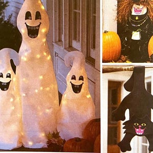 May include: Three light-up ghost decorations with smiling faces, perfect for Halloween. The ghosts are white with black eyes and mouths, and are lit with small, warm-toned lights. Pumpkins are in the foreground. A witch and a black cat decoration are also shown.