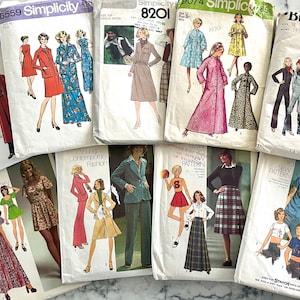 May include: A collection of vintage sewing patterns featuring illustrations of 1970s fashion. The patterns showcase various styles, including dresses, suits, and separates, with text such as "Simplicity" and "Butterick" visible on the covers.