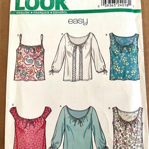 May include: A New Look sewing pattern featuring various blouse designs. The pattern includes illustrations of tops with different sleeve lengths, necklines, and prints. The size range is A 8-18.