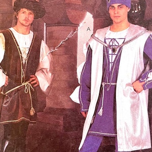 May include: Two men's costumes for a medieval or renaissance theme. The costume on the left is brown with a white shirt and a brown belt. The costume on the right is white with a blue vest and a blue sash. Both costumes have a white collar and a white trim.