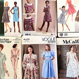 May include: A collection of vintage sewing patterns featuring illustrations of dresses. The patterns include various styles, from casual shirt dresses to formal gowns, with a range of colors and patterns. Brands include Vogue, McCall's, and Very Easy Very Vogue.