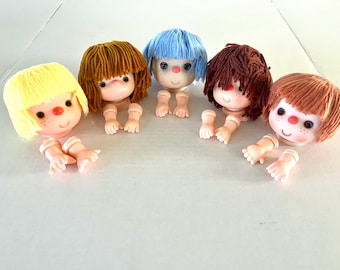 Vintage 1980's 4-inch Mitzy yarn-haired doll heads w/matching pair of arms/hands, blue haired doll's eyes open and shut, selling separately.