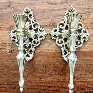 Set of 2 vintage ornate gold metal candlestick sconces, hangars on the back, heavy, solid, gorgeous; each 11&quot; tall x 4&quot; deep x 5 5/8&quot; wide.