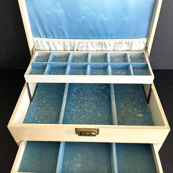 Large vintage Mele 'magic touch' jewelry box with blue velvet and satin interior, pockets, hooks, drawer opens when lid is lifted.