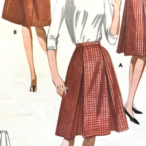 May include: Vintage sewing pattern featuring illustrations of women's skirts. The skirts are shown in a red and white checkered pattern and a solid brown color. The models are wearing white tops. The word "Butter" is printed in large black letters on the left side.