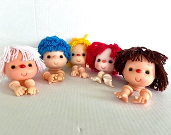 New vintage 4-inch doll heads with yarn hair, Ice Cream Doll, Strawberry Shortcake, Mitzy, pair of arms with each head, excellent condition.