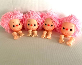 New vintage 3.5" doll heads with pink yarn hair and matching arms, blue eyes, freckles, pink nose, excellent condition.