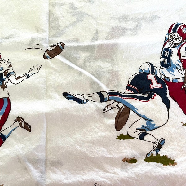 Pottery Barn twin-sized flat all-cotton sheet featuring American football players in red, white, brown and blue, excellent condition.