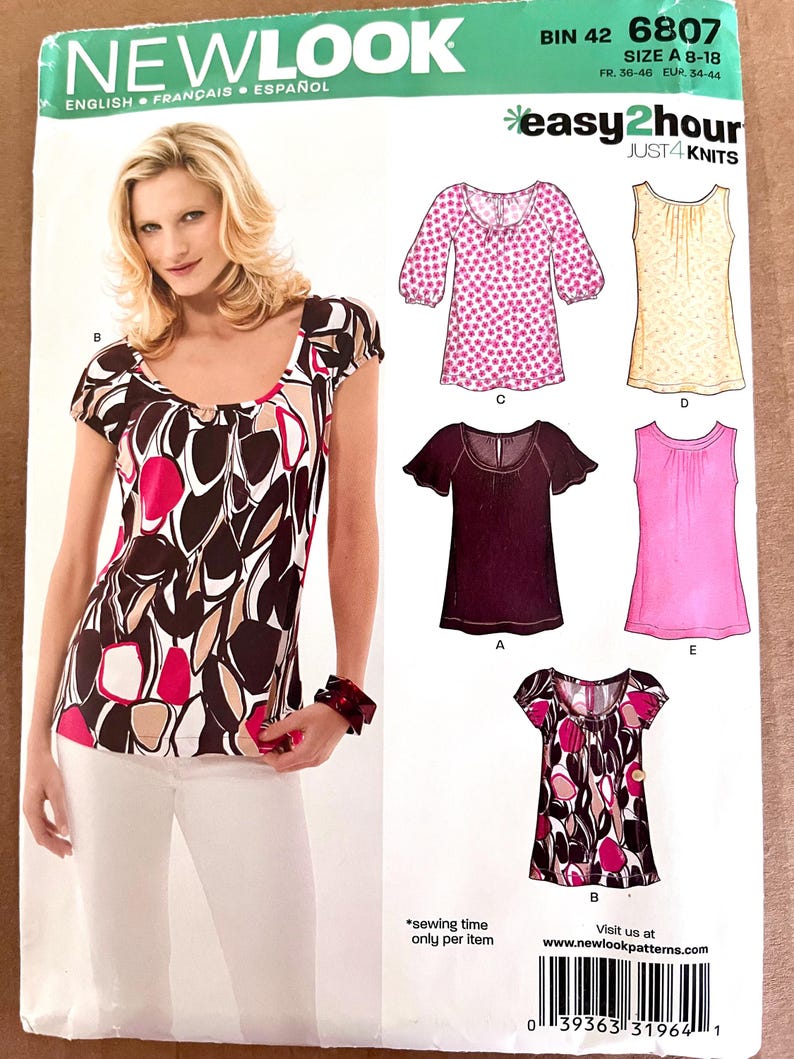 May include: A New Look sewing pattern featuring a woman wearing a scoop-neck top with a brown, pink, and white abstract design. The pattern includes multiple top styles, with the text "easy2hour JUST4 KNITS". The pattern size is A 8-18.