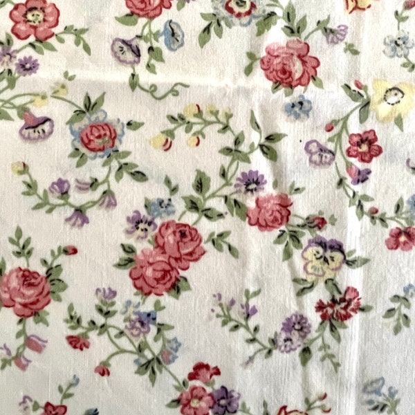 Vintage full-sized flat floral sheet, cotton poly blend, small florals in dark pink, lavender, yellow, blue, green on off-white, no flaws.