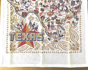 Nuovo canovaccio da cucina o da tavola "Texas" in puro cotone di Keep the Faye; oro, rosso, blu su bianco, 67 x 48 cm.