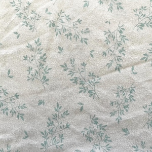 Queen-sized flat bed sheet, 100% polyester, sprigs of aqua florals on bright white, excellent condition.