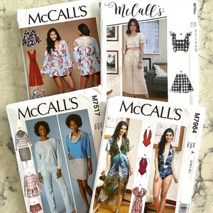 May include: Four McCall's sewing patterns featuring different clothing designs. The patterns are for sizes XS-XL and include instructions for making a variety of garments, including a dress, a top, a skirt, pants, and a swimsuit.