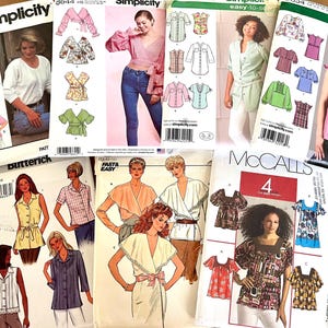May include: A selection of sewing pattern envelopes displaying designs for blouses and tops. The patterns include wrap tops, button-down shirts, and ruffled blouses. The envelopes show images of the finished garments and feature the brands Simplicity, Butterick, and McCall's.