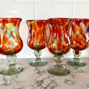 Set of 4 hand-blown goblets from Mexico in bubbled greenish glass base and stem, multicolored bubbled glass bowl; each approx. 6.75&quot; tall.