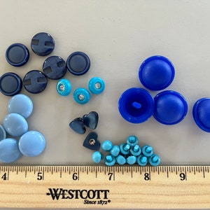 Vintage lot of 34 blue buttons of all sizes and shapes, bright royal blue to dusky blue, all with back shanks, some with rhinestone centers.