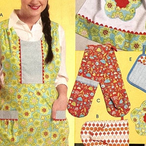 May include: A set of kitchen accessories featuring a floral print with green, blue, red, and white colors. The set includes an apron, oven mitts, and pot holders. The apron has a large pocket and a scalloped edge. The oven mitts have a floral print on one side and a solid color on the other. The pot holders are shaped like flowers and have a scalloped edge.