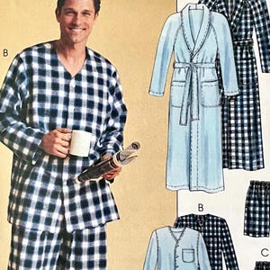 May include: A sewing pattern envelope featuring illustrations of loungewear including a long-sleeve button-down shirt, matching pants, a robe, and shorts in solid light blue and navy blue plaid patterns, labeled with letters B, C, and D.