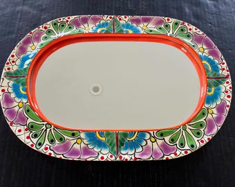Vintage Talavera Mexican mirror, hand-painted clay exterior with a hole in the back for hanging, terrific condition; 16" x 10 7/8".