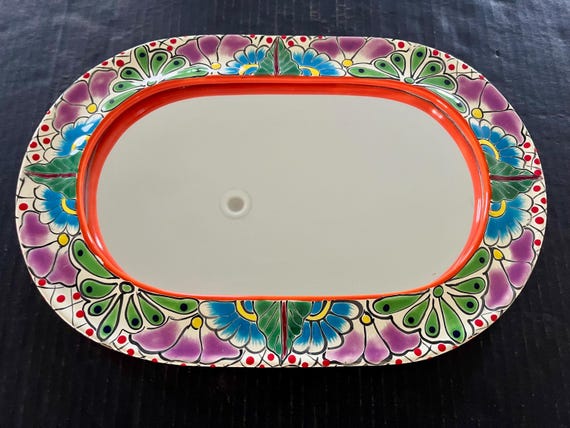 Vintage Talavera Mexican mirror, hand-painted clay exterior with a hole in the back for hanging, terrific condition; 16" x 10 7/8".