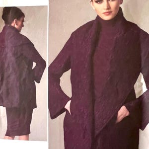 Pode incluir: Ilustração de moda com uma mulher em um conjunto roxo escuro. A roupa inclui um casaco comprido com mangas largas e uma saia a condizer. O casaco tem um design drapeado único. A modelo também está usando uma gola alta.