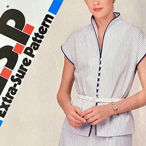 May include: A Simplicity Extra-Sure Pattern featuring a striped top and skirt set. The top has a mandarin collar, button-down front, and navy blue trim. The set includes a white belt. The pattern is for a women's clothing set.